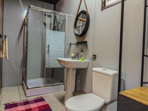 a bathroom with a sink and a shower and a toilet at Tekehani Lodge in Araito