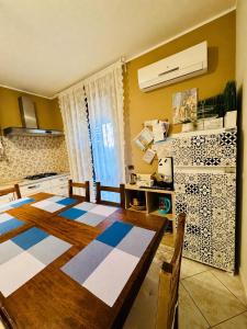 a kitchen with a wooden table and a kitchen with a kitchen at Villa Romano in Nicolosi