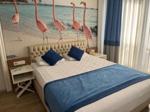 a bedroom with a bed with pink flamingos on it at River suite hotel in Manavgat