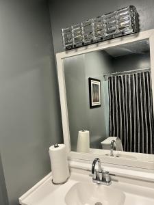 a bathroom with a sink and a mirror at The Haven at Mariama House in Upper Marlboro