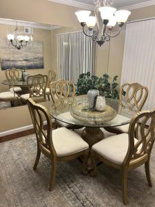 a dining room with a glass table and chairs at The Haven at Mariama House in Upper Marlboro