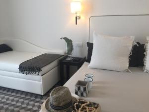 ベッラーリア・イジェア・マリーナにあるHotel Capanniのベッドルーム(ベッド、帽子付)