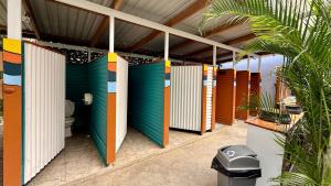 a row of stalls in a bathroom with a toilet at Casa Wolaba in Puerto Viejo