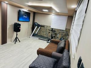 a living room with a couch and a gym at BaseCotopaxi Mini depart 5p free parking in Latacunga