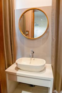 a bathroom with a sink and a mirror at Ricefield View 2 BR villa near Canggu in Dalung +15 photos