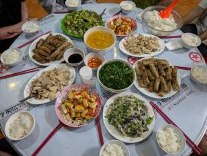 a table with many different dishes of food on it at Mắn Mẩy homestay in Tả Van