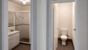 a white bathroom with a toilet and a shower at Beachside on Kent in Busselton +16 photos