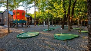 a playground with green trays on the ground at Creek,Pool,Playhouse celebration estate, sleeps 21 in Broken Bow