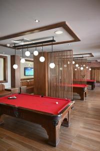 a billiard room with a red pool table in it at Sharm Hills Azure Suite Topview in Sharm El Sheikh