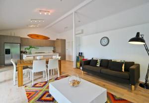 a living room with a couch and a table at Edgewater on Quindalup Beachfront in Quindalup