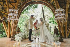 a bride and groom signing the register at their wedding at Ulaman Eco Luxury Resort in Tabanan +124 photos