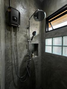 a shower with a shower head in a bathroom at Glai boutique hotel in Ban Cha Prong +54 photos