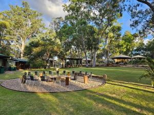 a circle of chairs and a table in a park at Wallaroo Outback Retreat - Glamping Tents Carnarvon Gorge in Hutton