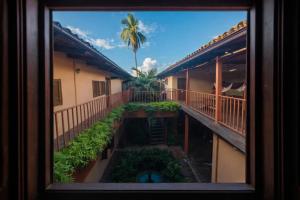 a view from a window of a building with a palm tree at Hotel El Maltese - Lakefront in Granada