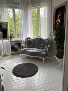 a living room with a couch in front of windows at Villa Tornhaga in Oskarström