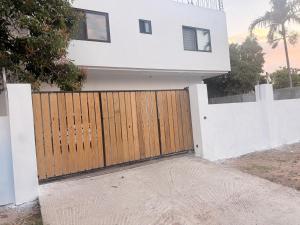 a house with a wooden gate in front of it at Modern Caribbean retreat 2 in Kingston