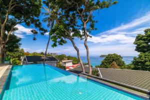a swimming pool with a view of the ocean at Anthiya Seaview Villa Hotel Phuket in Kata Beach