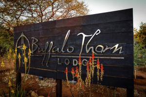 a sign for a wildlife museum with flowers on it at Buffalo Thorn Lodge in Pilanesberg