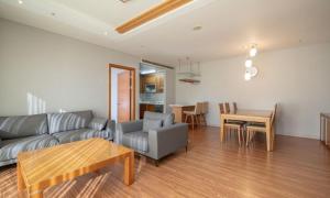 a living room with a couch and a table at Elysian Gangchon Resort in Chuncheon