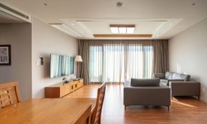 a living room with a couch and a table at Elysian Gangchon Resort in Chuncheon