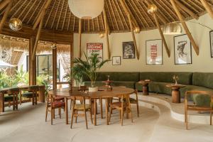 a dining room with a table and chairs at Hotel Together Bali in Uluwatu