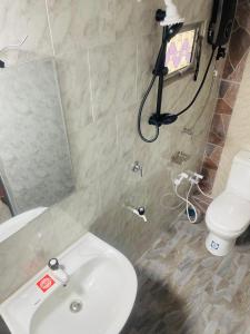a bathroom with a white sink and a toilet at Veenu Homestay in Badulla +2 photos