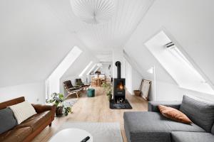a living room with a couch and a fireplace at Holiday Apartment On Bornholm With Sea View in Svaneke