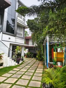 a courtyard of a house with a yellow chair at Sapphire Stayss in Yelagiri