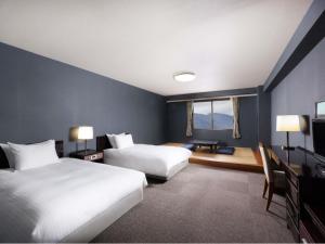 a hotel room with two beds and a window at Mercure Miyagi Zao Resort & Spa in Zao +121 photos