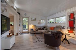 a living room with a couch and a table at Close To The Beach And Forest And Ebeltoft in Ebeltoft