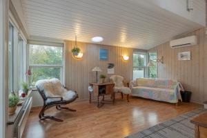 a living room with a couch and a chair at Close To The Beach And Forest And Ebeltoft in Ebeltoft