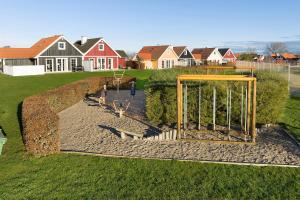 a playground in a yard with a basketball hoop at Charming Terraced House By The Beach And Forest in Bro