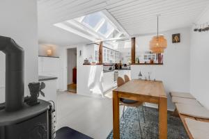 a kitchen and dining room with a table and a stove at Unique Holiday Home In Quiet Surroundings in Storvorde