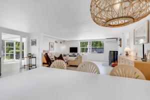 a living room with white walls and a chandelier at Unique Holiday Home In Quiet Surroundings in Storvorde