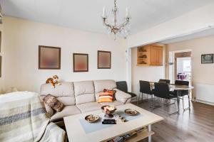 a living room with a couch and a table at Spacious House With Sea Views From All Rooms in Rønne