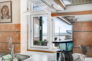 a kitchen with a sink and a window at Spacious House With Sea Views From All Rooms in Rønne +17 photos