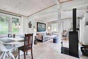 a kitchen and living room with a table and chairs at The Sun House in Hundested +20 photos