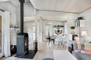 a living room with a wood stove in a house at The Sun House in Hundested