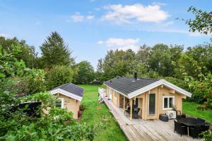 a tiny house with a porch and a deck at The Sun House in Hundested