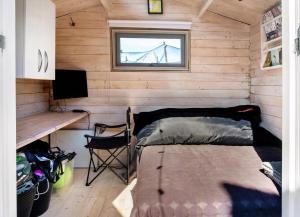 a room with a bed and a desk and a window at Exclusive Architect Designed Beach House in Karrebæksminde