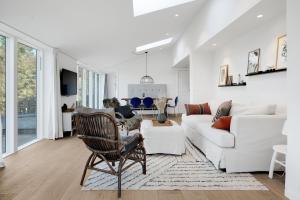 a living room with a white couch and a table at Unique New Beach-House I Seaview And Space in Vejby