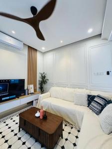 a living room with a white couch and a table at Bayu senja in Lahad Datu