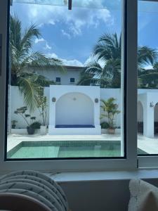 a view of a pool through a window at Bayu senja in Lahad Datu +18 photos