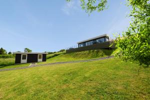 a house on top of a grassy hill at Modern Holiday Home On Adventurous Bornholm in Allinge