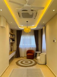 a living room with a yellow ceiling at Bayu senja in Lahad Datu