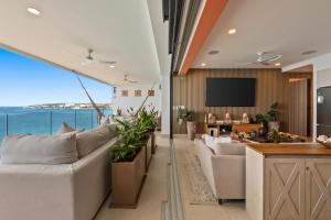 a living room with white furniture and a view of the ocean at PANAREA - Luxury Beachfront Condos in Bucerias in Bucerías