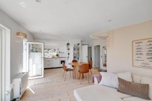 a living room with a couch and a table at Beautifully Situated Summer House With Sea View in Allinge