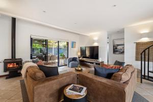 a living room with two couches and a fireplace at Sidney Laine - Family Friendly - Private in Margaret River Town