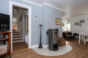 a living room with blue walls and a fireplace at Cozy Central Located Townhouse In Nakskov in Nakskov