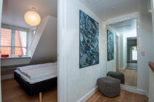 a room with a bed and a mirror at Cozy Central Located Townhouse In Nakskov in Nakskov